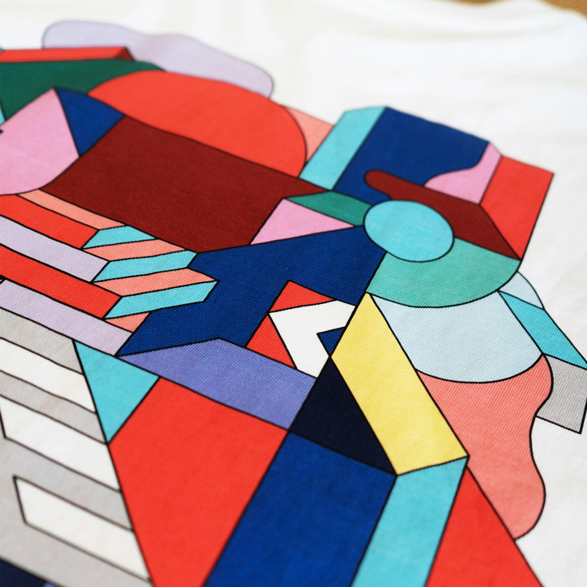 Example output: close up of a full color geometric print on a white tee