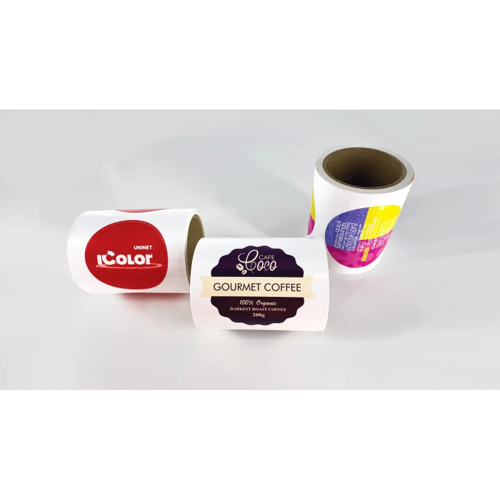Three finished label rolls from the UNINET Label Printer with logo, coffee, and multicolor designs