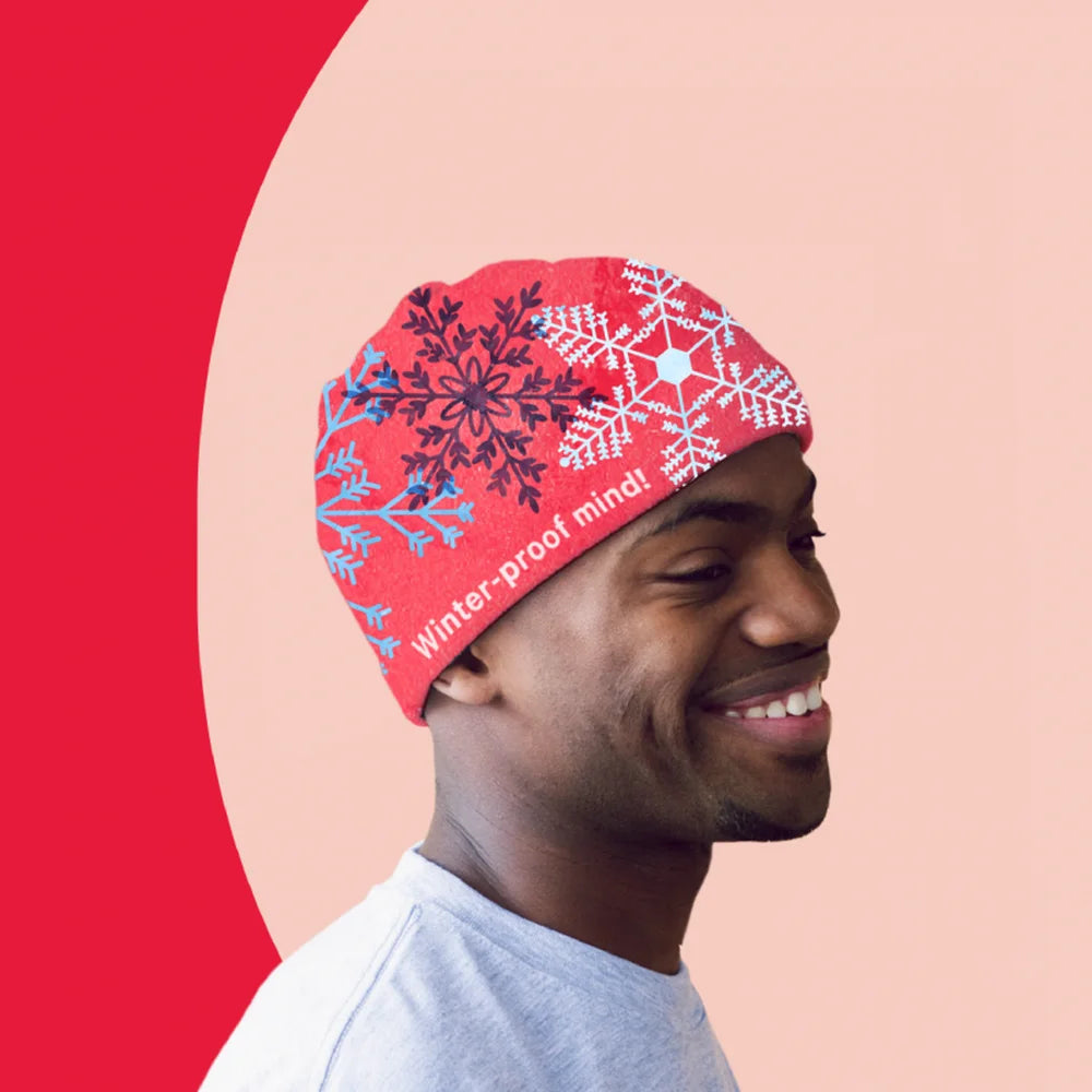 Red beanie with snowflake print worn by a smiling man made using UNINET IColor Premium 2 Step Transfer Paper Kit A4