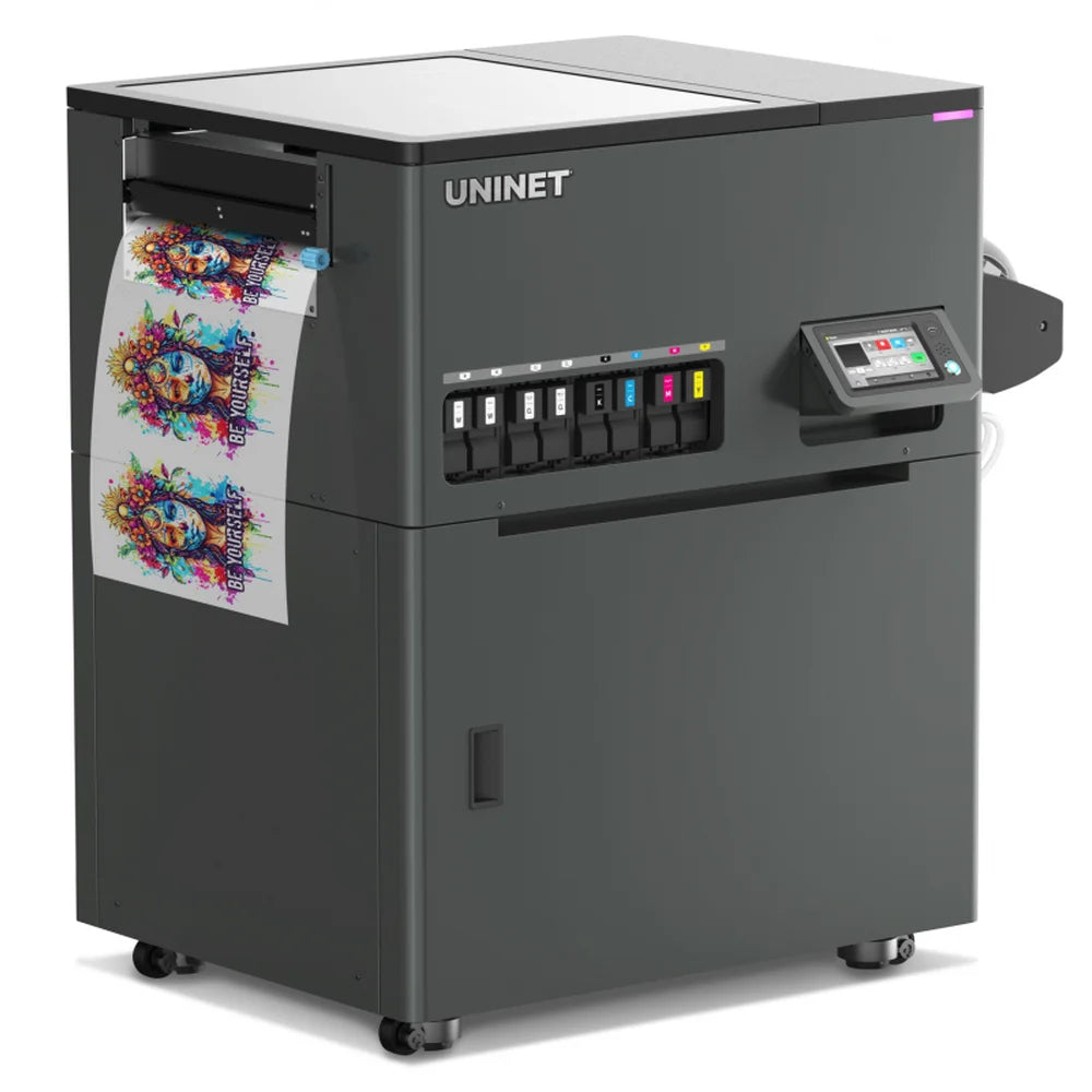 Skull and floral 'Be Yourself' transfer film feeds from the Icolorprint UNINET DTF Xpress 17 in Printer, ink bay and touchscreen visible on casters.