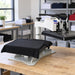 Black tee laid on the open table of the Geo Knight DK20S Digital Swing Away on a wood bench in a print shop
