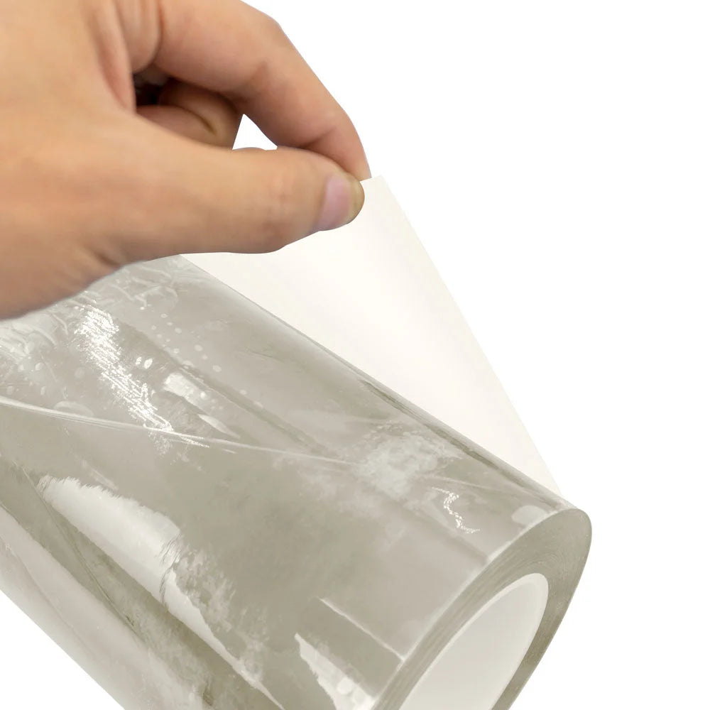 Hand lifting the protective layer from Procolored Clear UV DTF AB Film for A3 Printer A roll