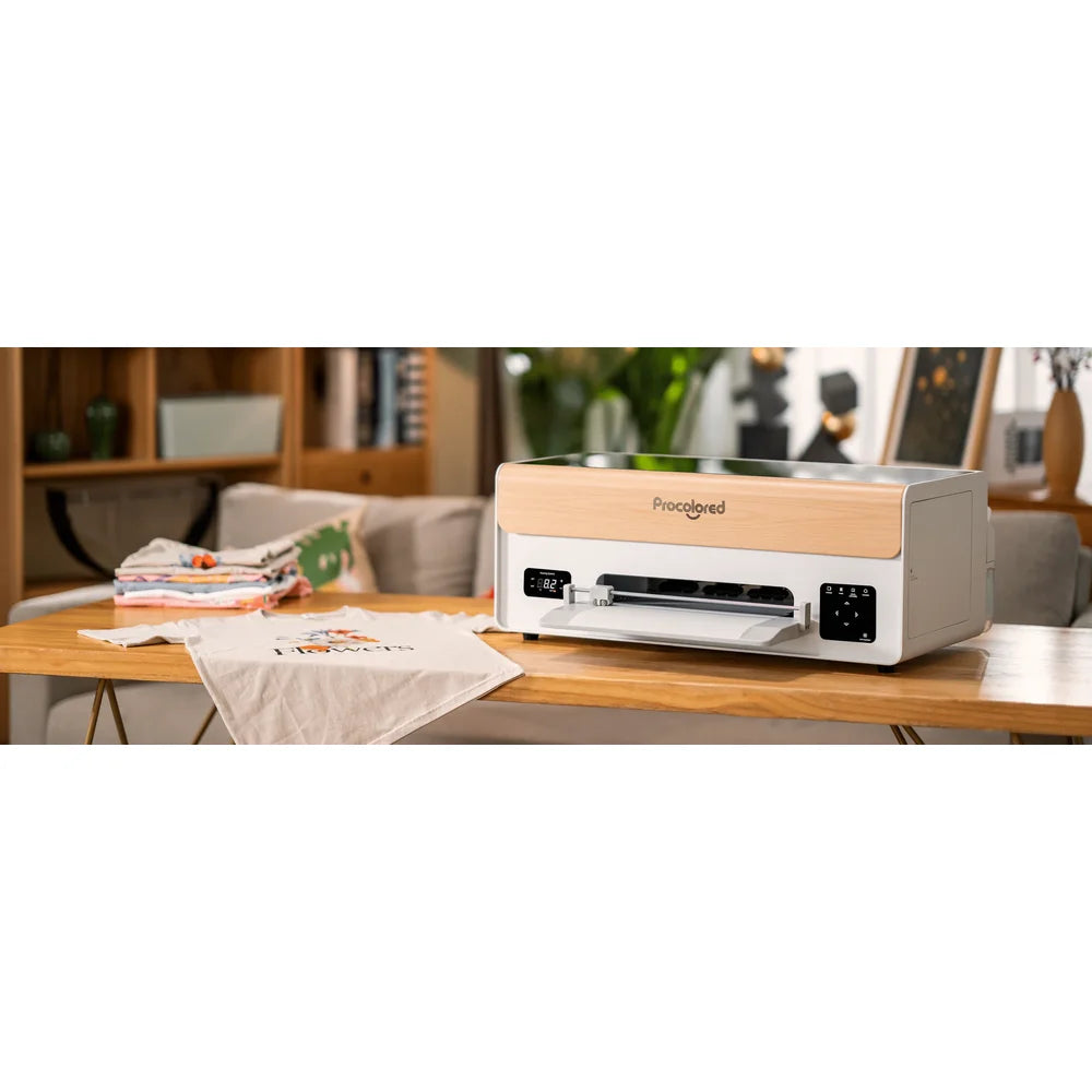 Compact procolored xp600 desktop DTF printer set up on a wooden table in a bright home living room with shirts nearby