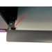 Detail of the uninet icolor 1200 film exit edge with a red arrow marking the black media guide clip on the front of the printer