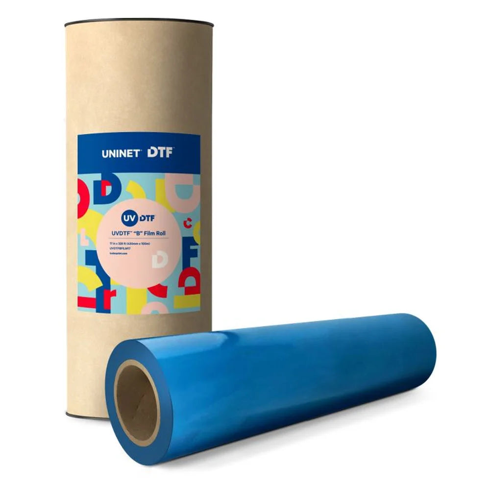 Blue B film roll rests in front of its kraft tube, part of the uninet uv dtf 3000 system, labeled 17 in x 328 ft.