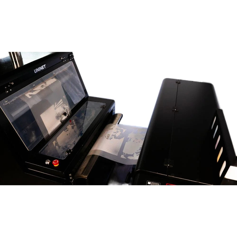 Wide DTF Roll Fed Printer with clear cover open showing printed film with white underprint feeding to the shaker