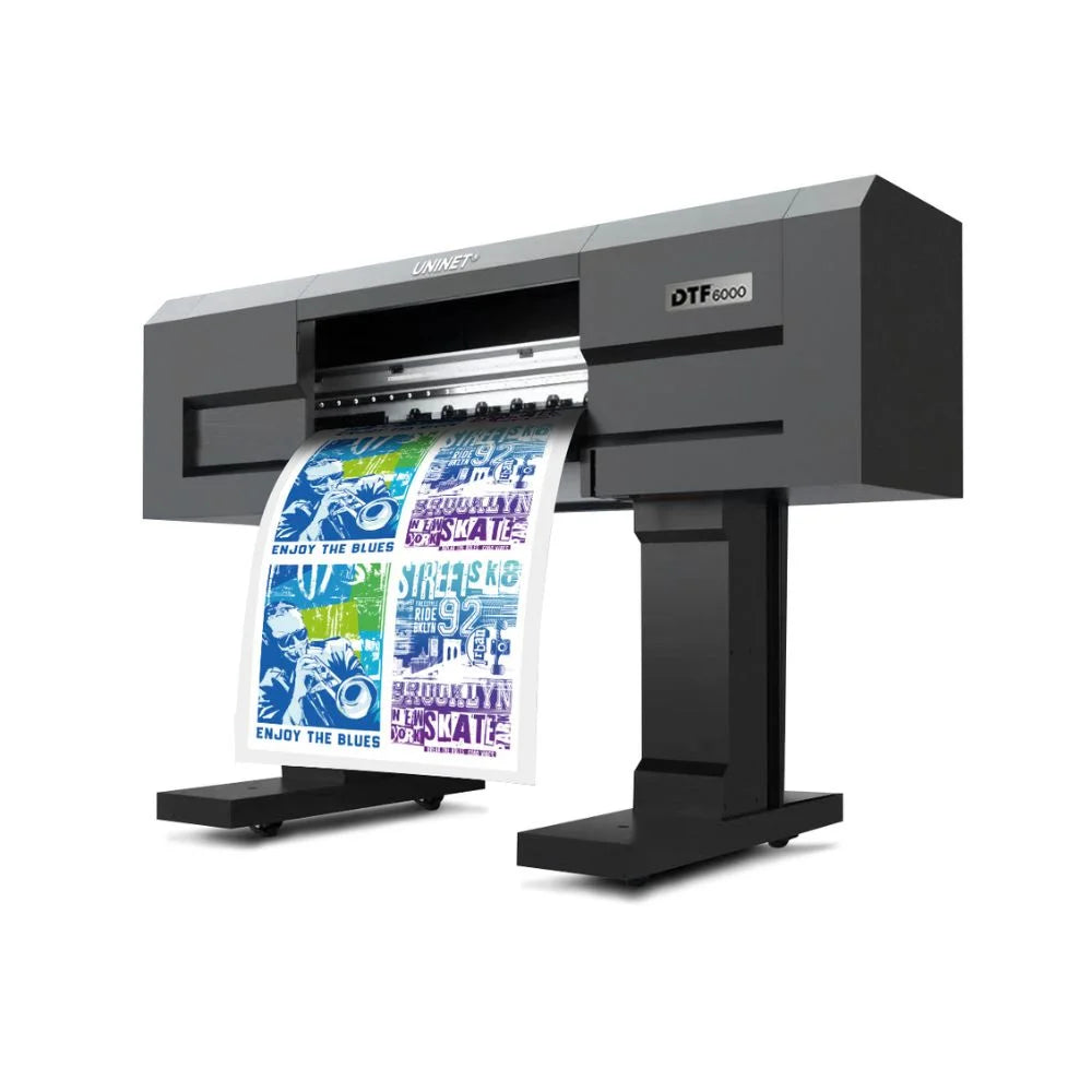 Angled front view of the uninet 6000 dtf printer with a colorful transfer film sheet curling out the front