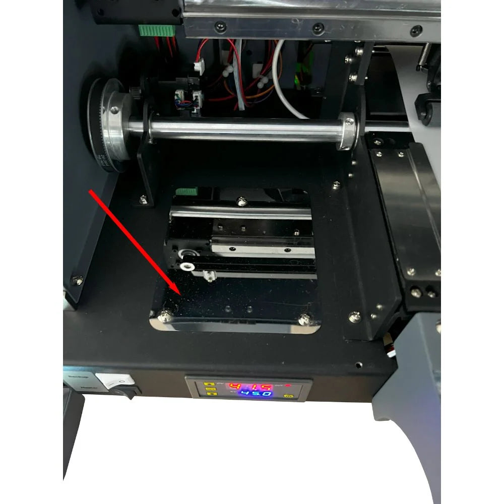Annotated interior of the uninet icolor 1200 showing the vacuum suction platform, feed roller shaft and heater temperature display