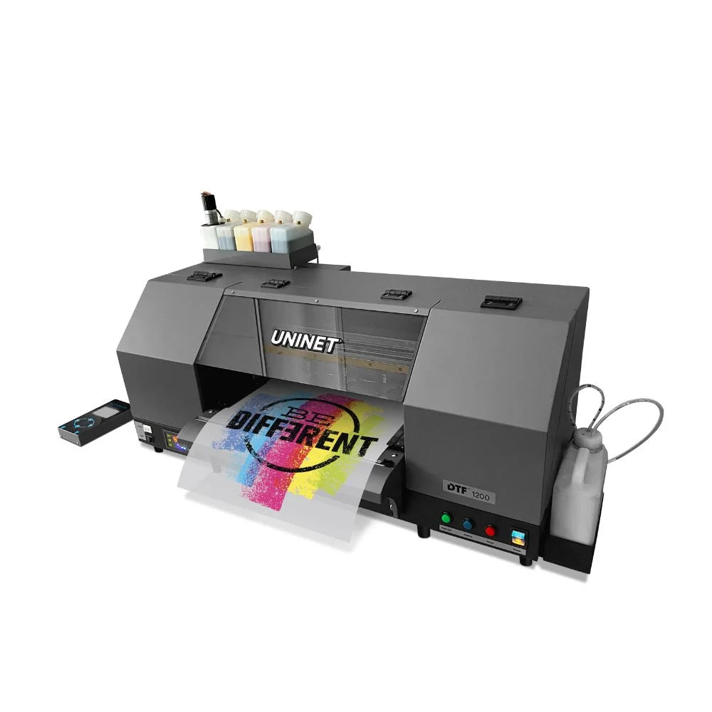 Overhead angled view of the Uninet DTF 1200 Dual Head Printer with ink bottles, waste bottle and a color transfer emerging
