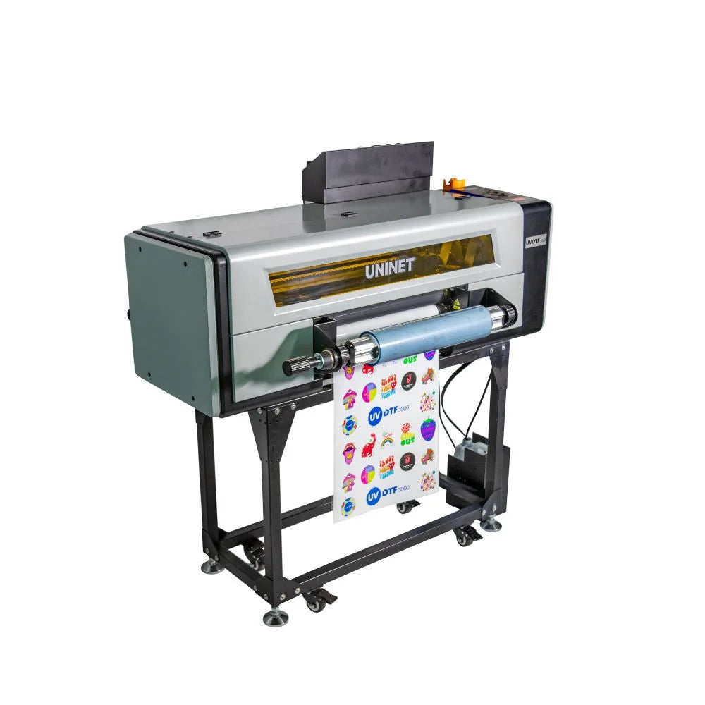 Side-angle view of the Wide UV DTF Roll Fed Printer on its stand showing the roll feed and printed sticker sheet