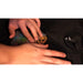Hands applying a finished transfer onto a black t-shirt as demonstrated in the UNINET White Toner Training Program