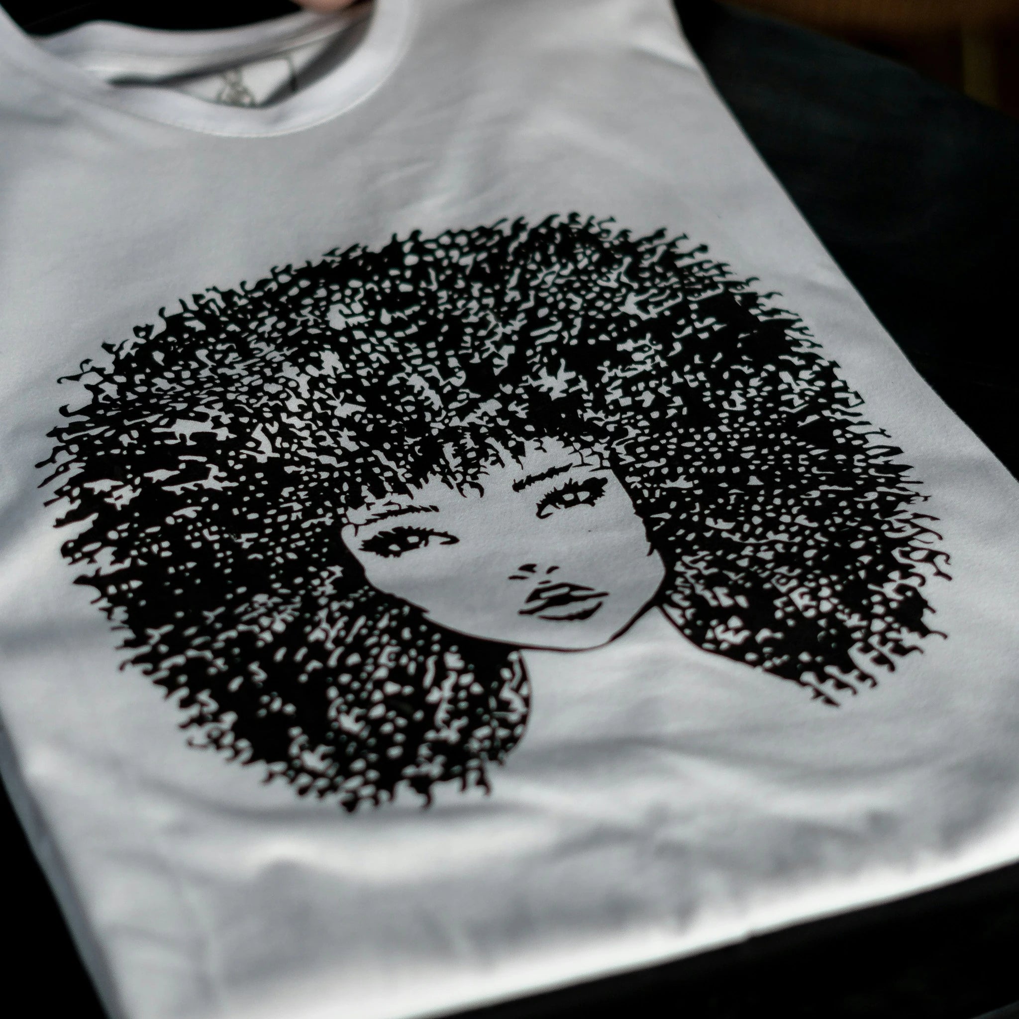 Example output: white tee with a black illustrated portrait print