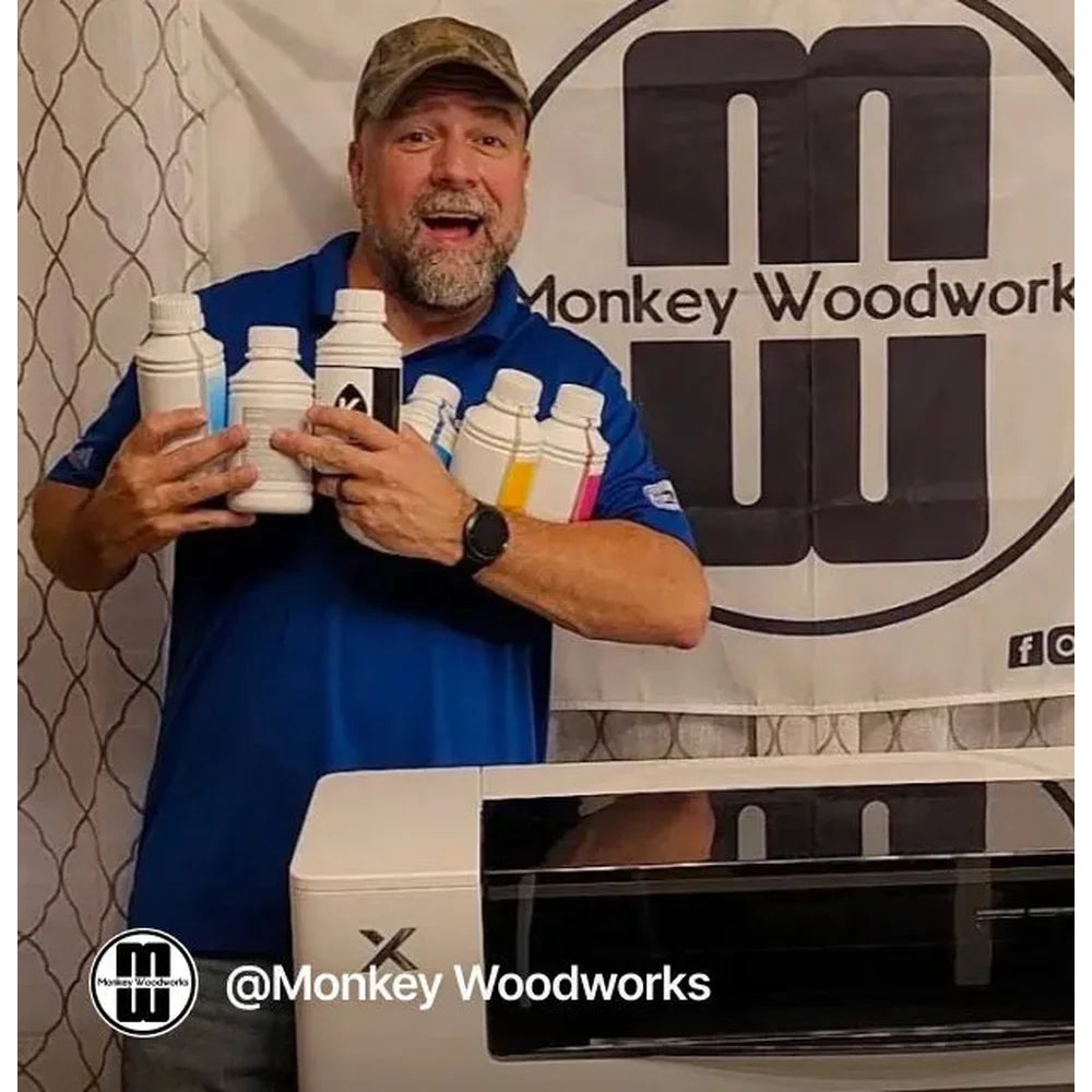 Workshop owner holds printer ink bottles behind the xTool Apparel Printer software unit