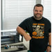 Owner in a Halloween shirt standing beside the xTool Apparel Printer in a home workroom