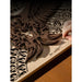 Hand removes tiny pieces from layered wood artwork cut with the xTool P3 during project finishing